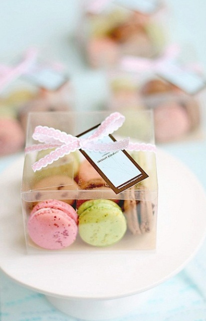 a clear box with colorful macarons as a lovely wedding favor for a modern wedding with plenty of color