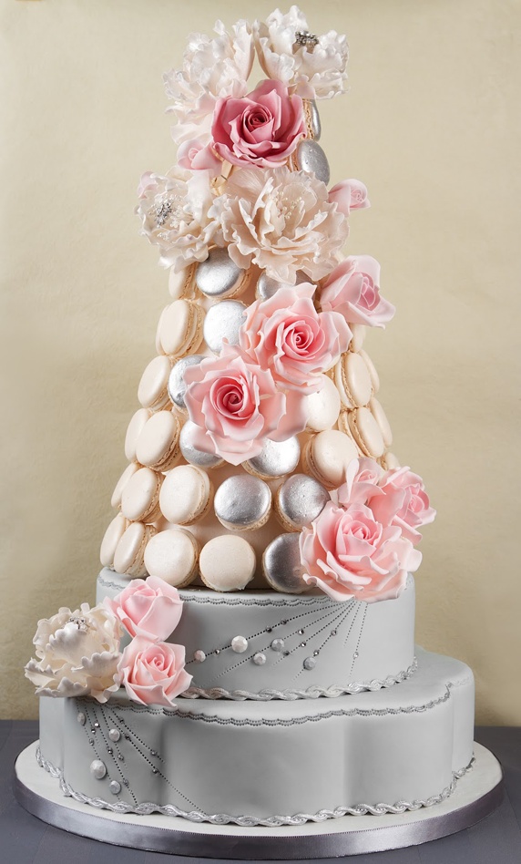 A refined and chic alternative to a wedding cake   a wedding macaron tower composed of gold, silver and creamy macarons decorated with fresh and sugar blooms