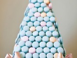 a pastel triangle tower of blue and pink macarons is a lovely and creative alternative to a usual wedding cake
