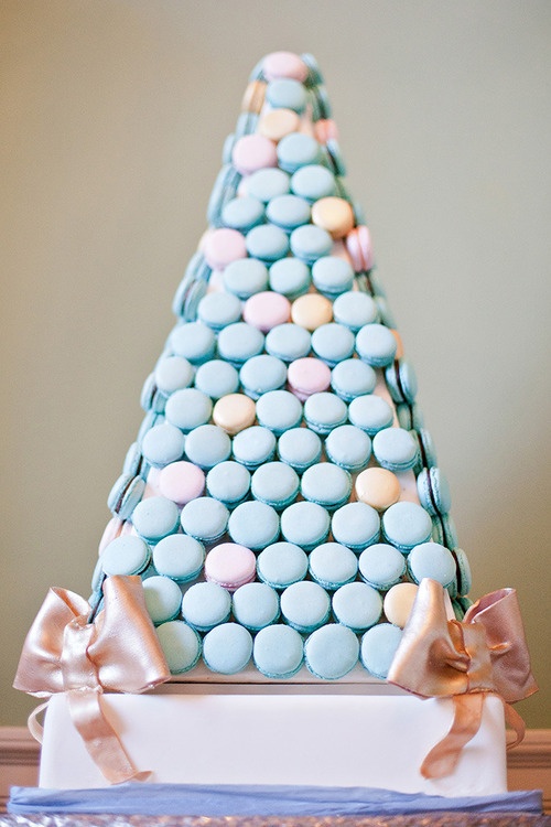 a pastel triangle tower of blue and pink macarons is a lovely and creative alternative to a usual wedding cake