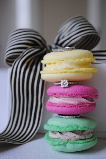 super colorful macarons with wedding bands stacked in between are a cool solution for a modern wedding with plenty of color