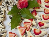 mini triangle cheesecakes with fresh strawberries on top and with chocolate patterns on top