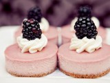 mini pink cheesecakes with cream and blackberries on top for a fall or summer wedding