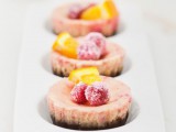 mini pink cheesecakes with sugared berries and citrus slices are amazing for a summer wedding
