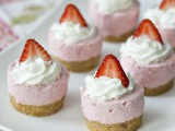 mini pink strawberry cheesecakes with cream and fresh berries on top are a timeless and tasty idea