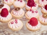 mini tartlets with pink whipped cream, edible beads, fresh raspberries, chocolate on top