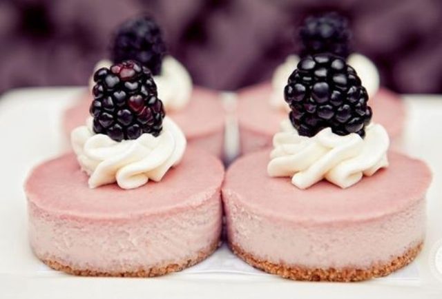 Mini berry cheesecakes with whipped cream and fresh blackberries on top are crowd pleasing, fresh and tasty