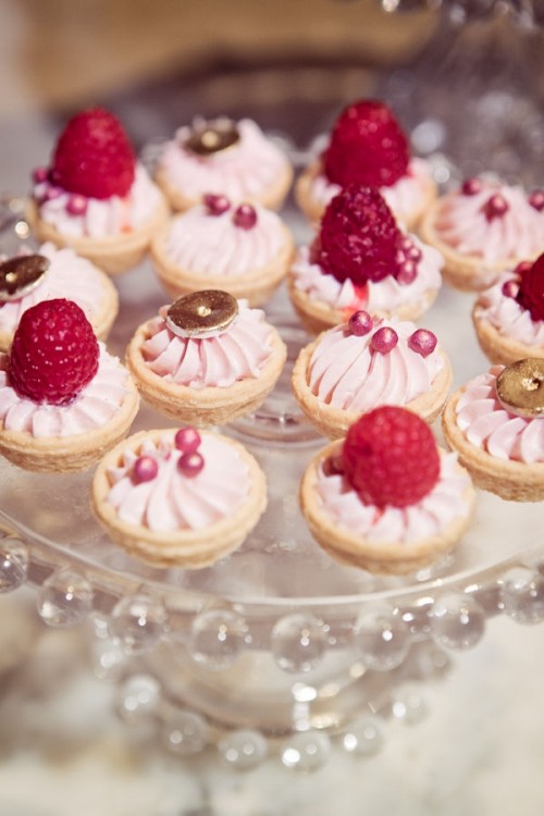 tartlets filled with strawberry cream and edible beads, fresh raspberries and touches of chocolate