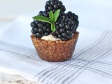 a mini tartlet filled with curstard and topped with blackberries is a delicious little dessert