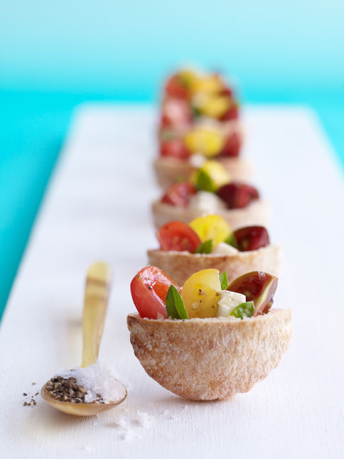 coconut halves with salad of tomatoes, lemons, fruits and fresh greenery is veyr refreshing