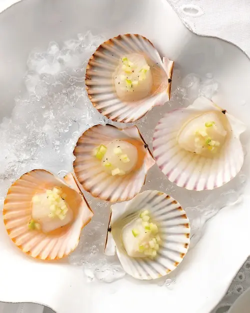scallops with some condiments are amazign for sea food lovers or for beach and coastal weddings