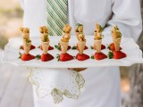 fried chicken in ice cream cones placed into strawberries looks very unusual
