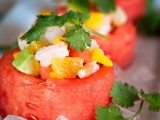 watermelon cups filled with fresh fruits salad topped with herbs are very refreshing