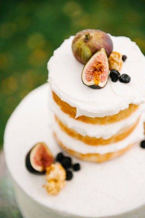 a naked wedding cake topped with fresh fruit and berries is a lovely idea for a fall wedding, whether it's a vineyard one or not