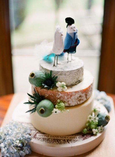 a catchy cheese wheel tower with blooms, thistles and seed pods plus creative bird cake toppers is an amazing idea for a vineyard wedding