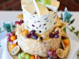 a cheese wheel wedding cake topped with fresh fruit and berries is a creative solution for a vineyard wedding for couple who don’t like sweets