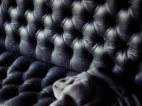 a black upholstered sofa is a cool idea for styling a soft gothic wedding lounge