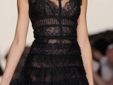 a semi sheer fitting black lace wedding dress with an illusion neckline, no sleeves
