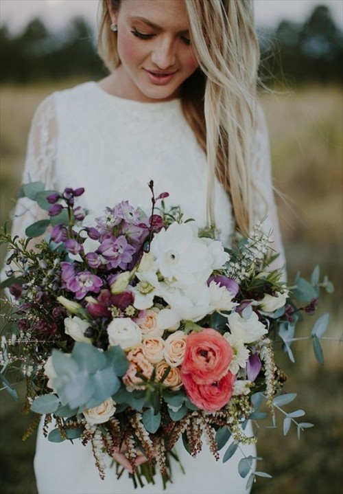 a bright wedding bouquet of white, coral and purple blooms and lots of pale greenery will fit a boho bride
