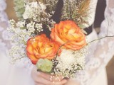 a fall boho wedding bouquet with orange blooms, baby’s breath, dried elements and grasses plus some greenery