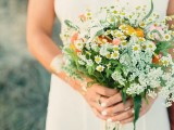 a neutral summer wedding bouquet in white, yellow with lots of wildfowers and some greenery