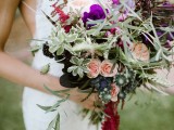 a bright wedding bouquet with blush and purple blooms, textural greenery, dried elements and grasses
