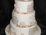 a neutral beach wedding cake with sugar fences, starfish, seashells and beach sand – everything edible