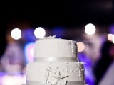 a super elegant white beach wedding cake with ribbons and sugar starfish and sea horses looks very chic and stylish