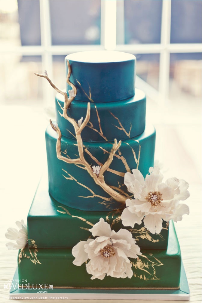 a green square and blue round wedding cake with sugar blooms and gold driftwood and painted gold branches on the cake