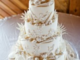 an all-white beach wedding cake decorated with seashells, corals and starfish, all made of sugar is lovely and it looks veyr seaside-like