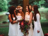 boho woodland bridesmaids wearing mismatching white lace dresses and feathers and a bride wearign a champagne-colored wedding dress