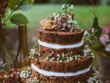 a woodland boho naked wedding cake with fresh blooms and leaves is a lovely idea for a summer or fall wedding