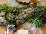 a woodland wedding centerpiece of a tree stump, greenery, moss and succulents is a rough and wild idea