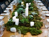 a woodland wedding centerpiece of moss, succulents, candles and some wildflowers can be easily DIYed