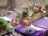 a bright tablescape with woodland touches – twigs, wooden planters with greenery and artichokes plus moss
