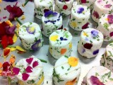 white wedding mini cakes decorated with colorful pressed edible blooms look very lovely
