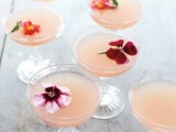such blush cocktails topped with edible blooms can be served for a spring or summer wedding or for a bridal shower, they look beautiful