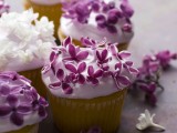 wedding cupcakes with some white and purple edible blooms on top are lovely wedding desserts that look amazing
