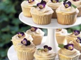 wedding cupcakes with vanilla frosting and violets are gorgeous wedding desserts for spring and summer celebrations