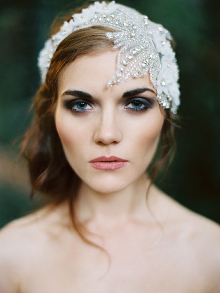 A white fabric floral headband with rhinestones and lace is a beautiful option for an art deco or vintage bride