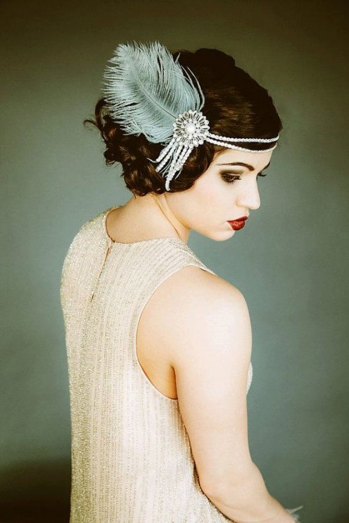 a pretty art deco headpiece of pearls, an embellishment and a blue feather is a lovely and whimsical art deco headband