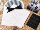 black and white wedidng stationery suite placed ona  gold sequin backdrop to show off the wedding color scheme
