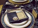 a very elegant and refined wedding tablescape with gold cutlery and brooches
