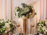 gold vases and cutlery, black and gold place settings, white bloom centerpieces