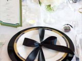 a black and gold place setting and a white tablescape with blooms