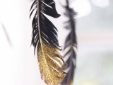 black and gold feathers will be a fun decor idea for such a wedding