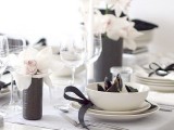 a chic neutral tablescape spruced up with black touches – vases, napkin rings, napkins and some other