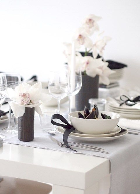 a chic neutral tablescape spruced up with black touches - vases, napkin rings, napkins and some other