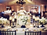 a cozy neutral tablescape with floral centerpieces and candles, touches of black – candleholders and vases