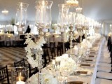 a white and silver tablescape with black chargers and menus to create a contrasting look